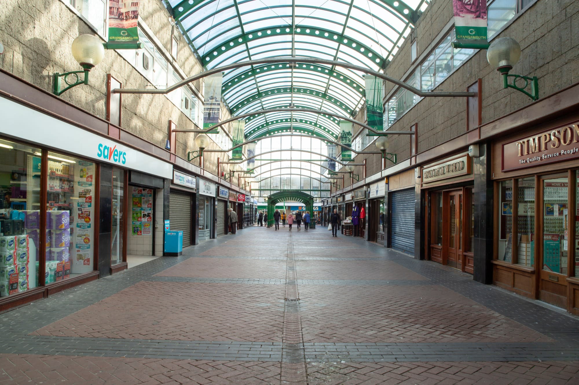 The inside of a historic shopping arcade boasting many shops