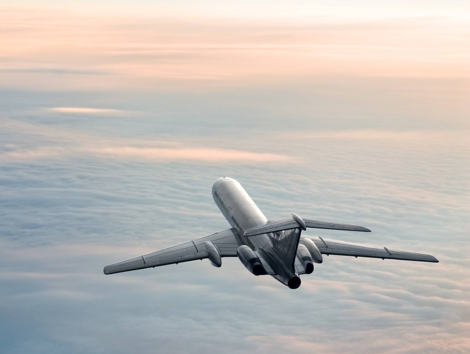 An airplane flying off into the sunset