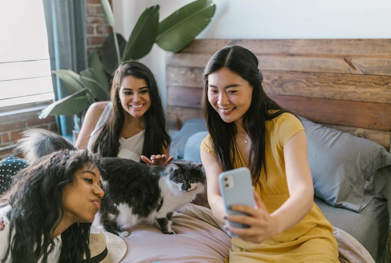 Three women and a cat relaxing