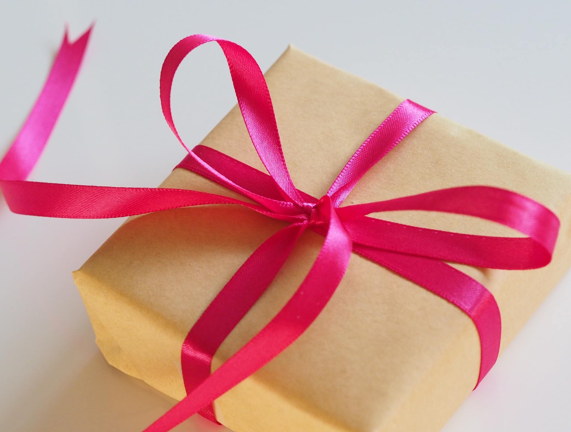 A box wrapped in brown paper and tied with a pink bow