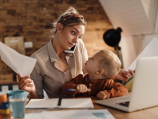 multitasking-working-mother-with-small-son-home_637285-10918