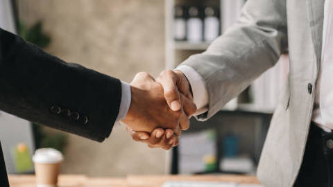two-confident-business-man-shaking-hands-during-a-meeting-in-the-office-success-dealing