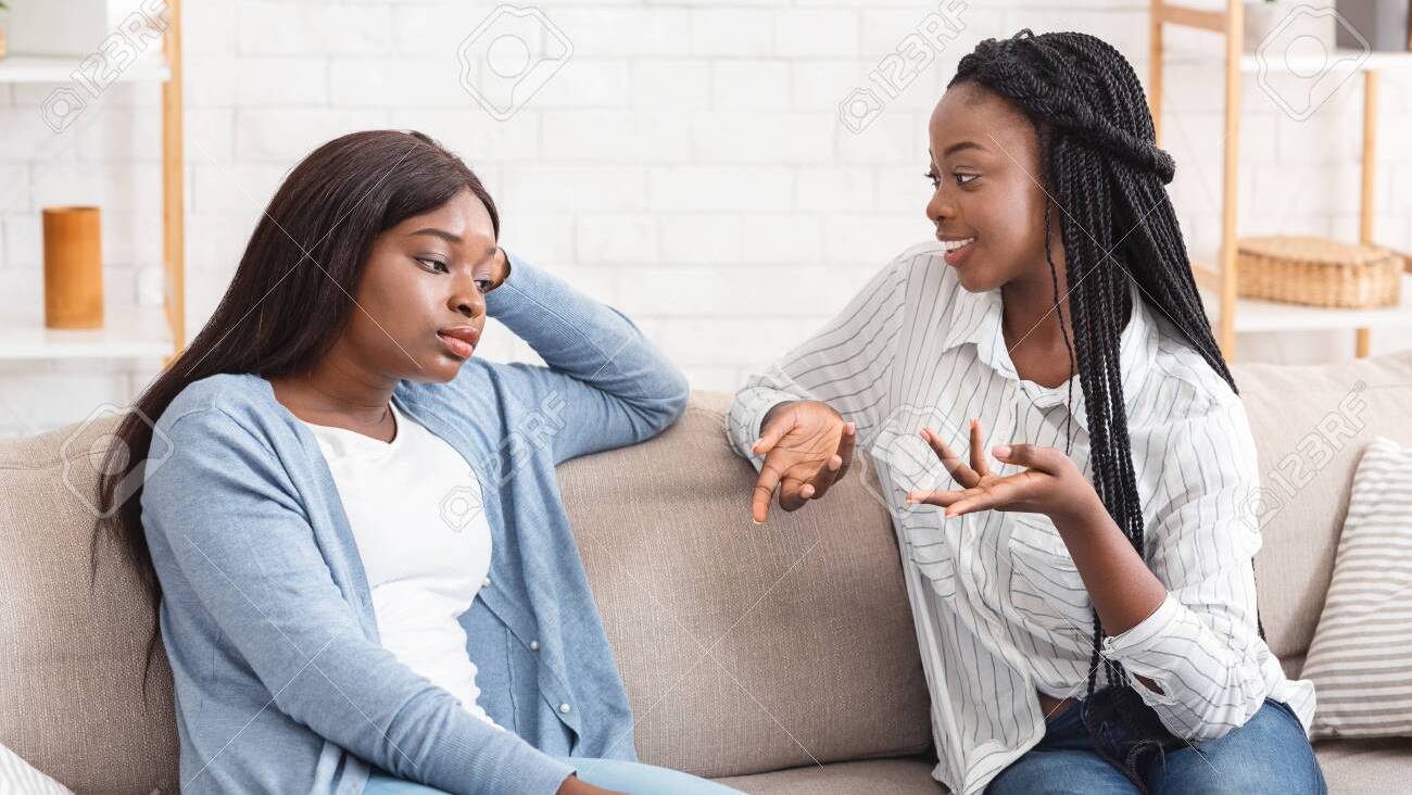 134603706-talkative-friend-concept-young-black-woman-tired-of-her-girlfriend-talking-non-stop-while-they