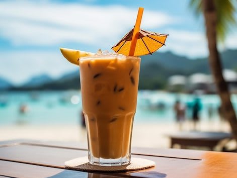 glass-iced-coffee-with-beach-background_391229-12449