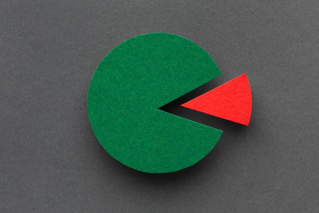 A pie chart made of felt. The largest part is green and one segment (detached) is red.