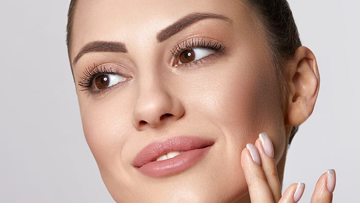 Woman-with-beauty-face-touching-healthy-facial-skin-portrait