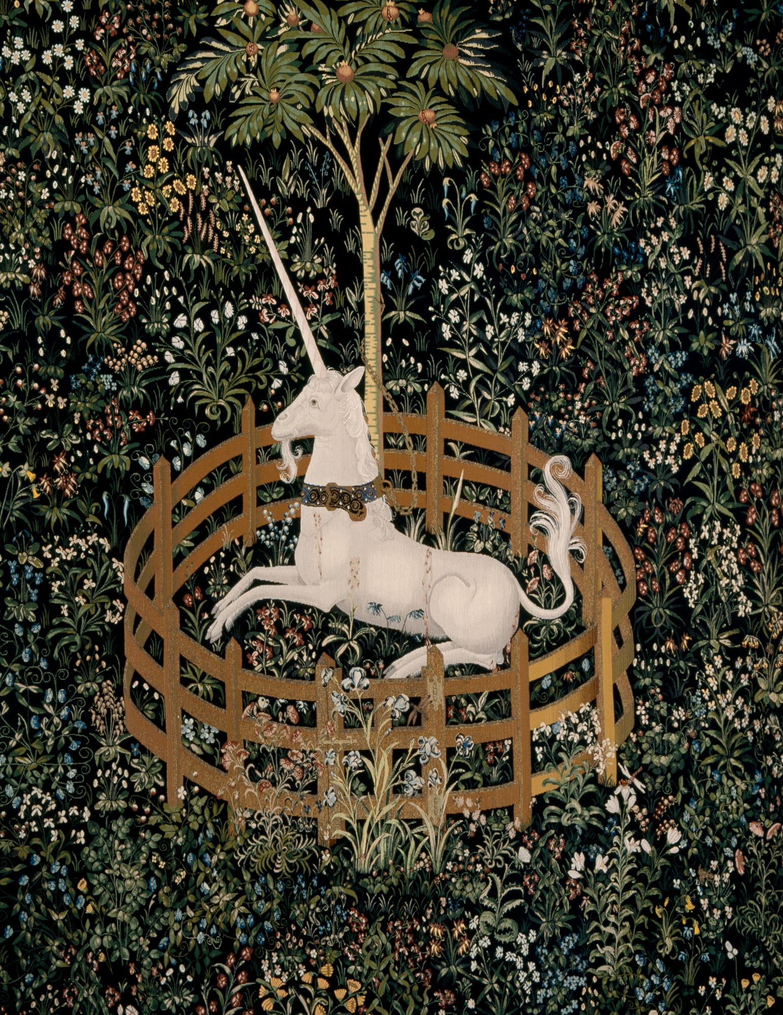 A unicorn in a pen, embroidered into a tapestry