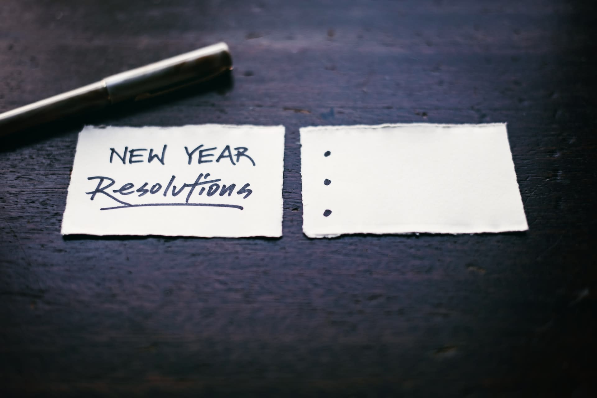 Two index cards, with 'New Year Resolutions' and some bullet points written on them