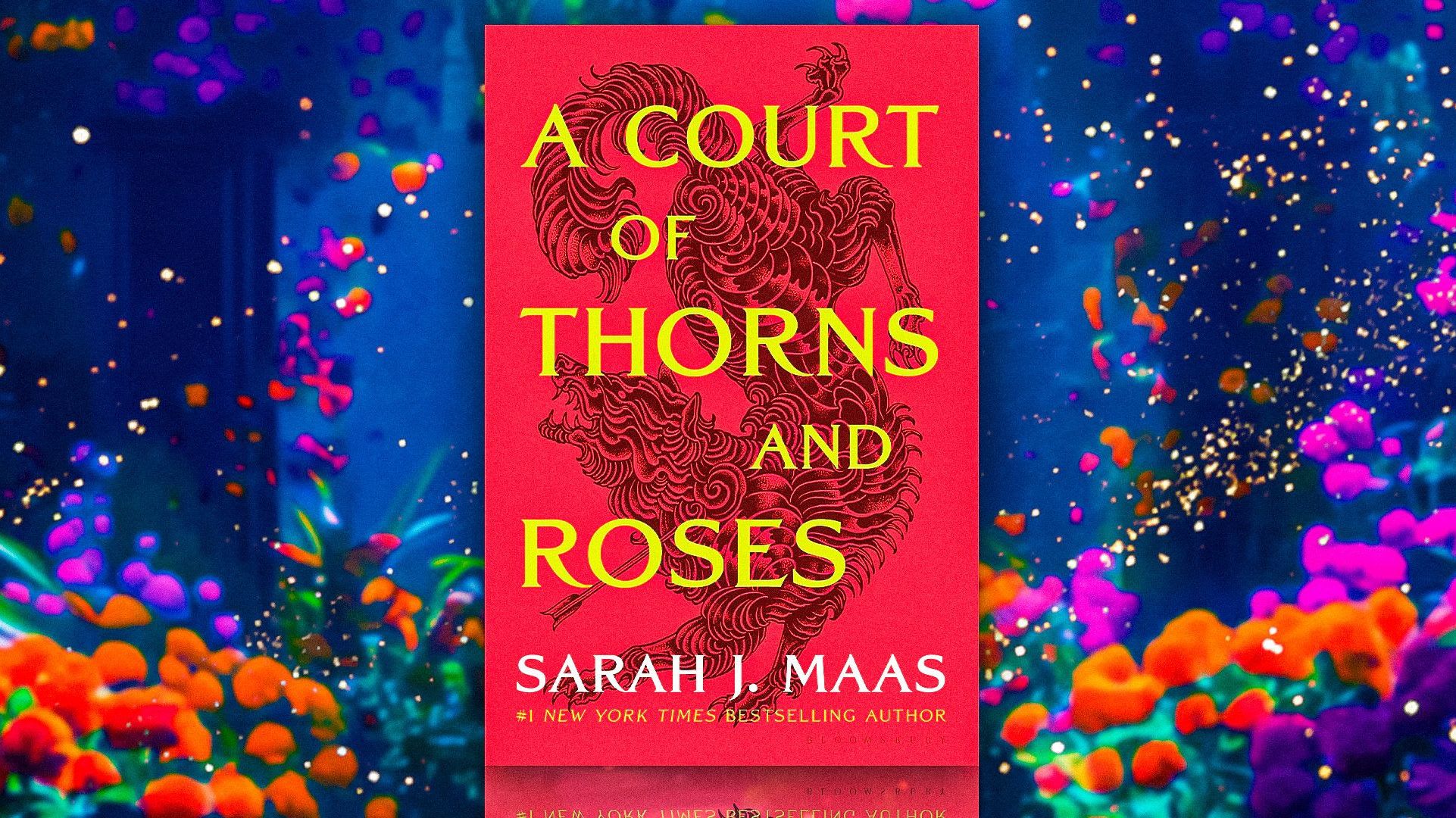 the-cover-of-a-court-of-thorns-roses-with-a-blue-background-and-flowers