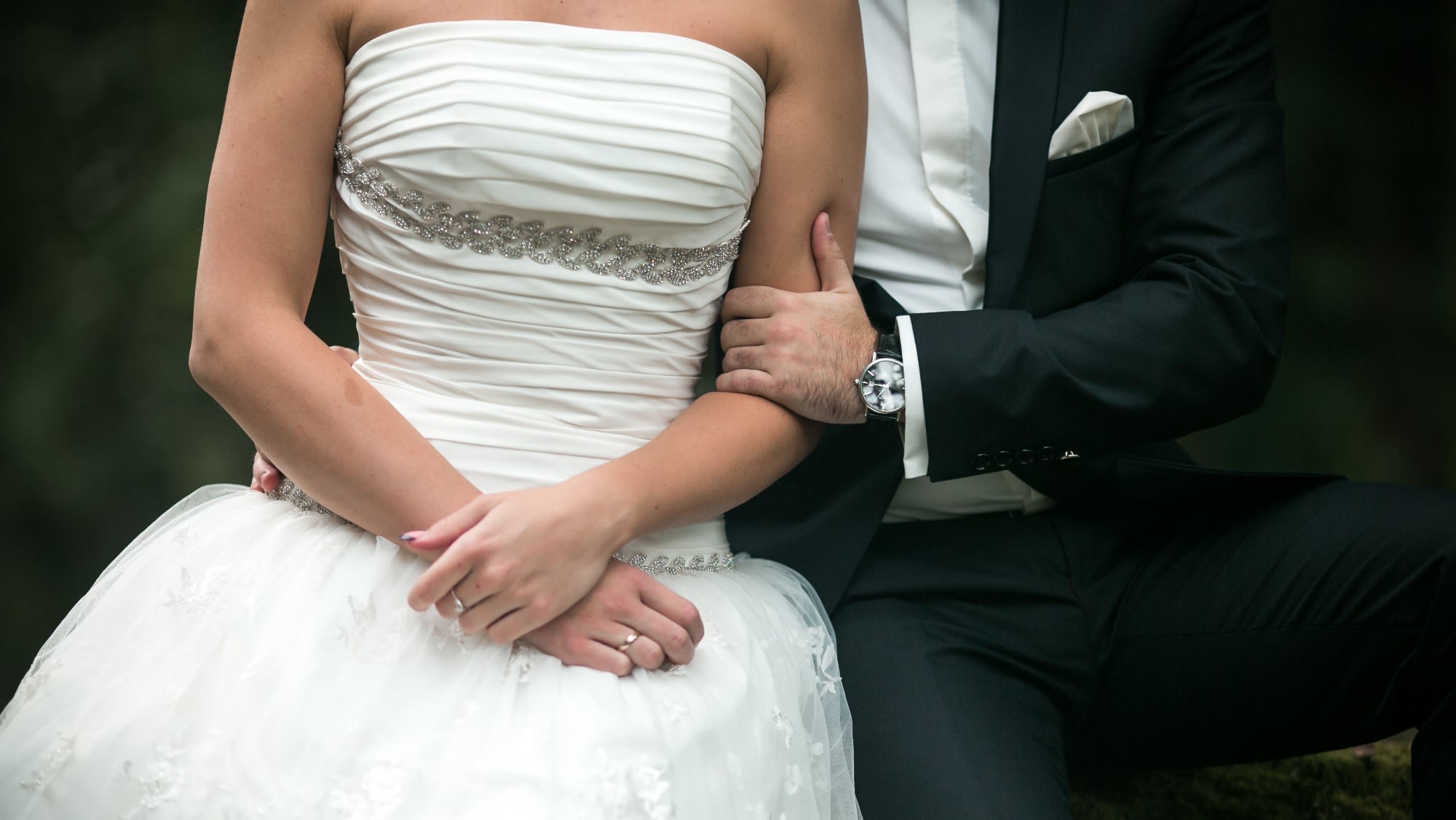 arm-man-grabbing-arm-woman-with-wedding-dress