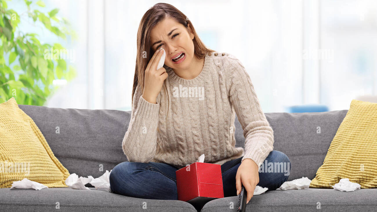 sad-young-woman-watching-television-and-crying-HEH3PP