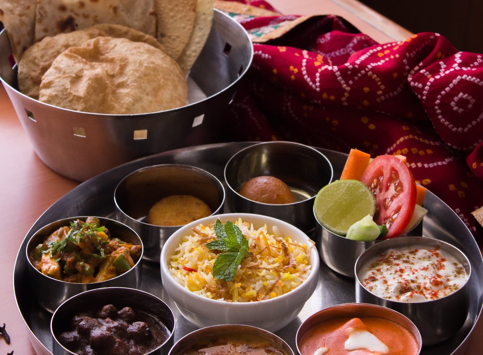 An assortment of rotis, rice and various chutneys/dishes/sweets