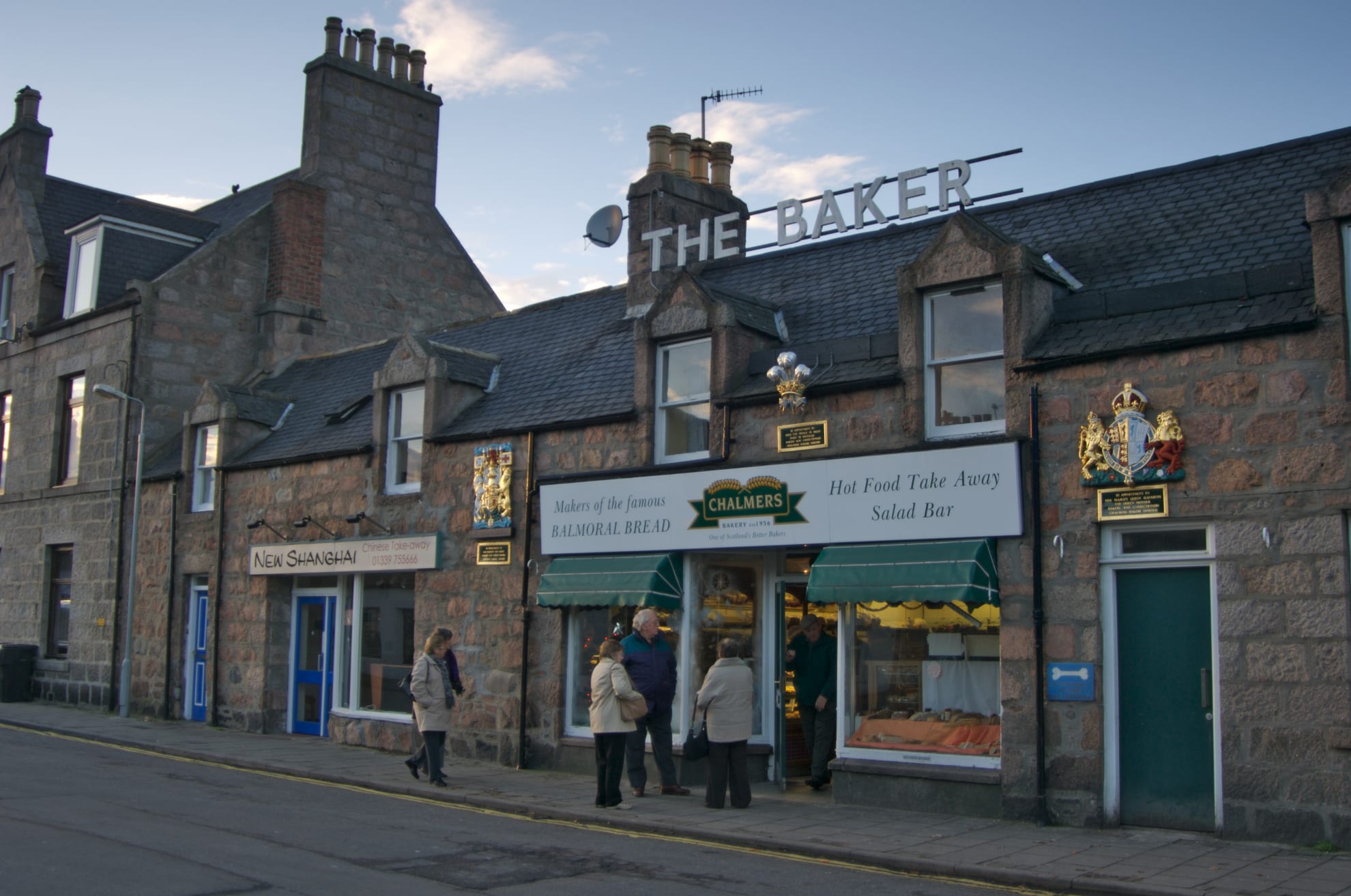 People standing outside a historic baker shop