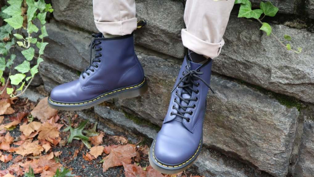 Model-sitting-on-the-wall-and-wearing-Dr-Martens-1460-1