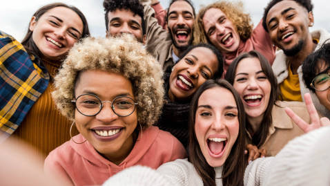 multiracial-friends-taking-big-group-selfie-shot-smiling-at-camera-laughing-young-people