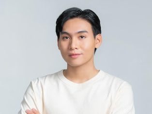 smiling-young-asian-man-with-arms-crossed-white-background_264197-32416