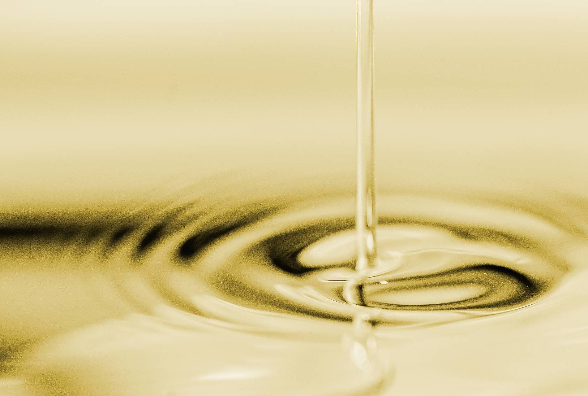 Light yellow oil being poured