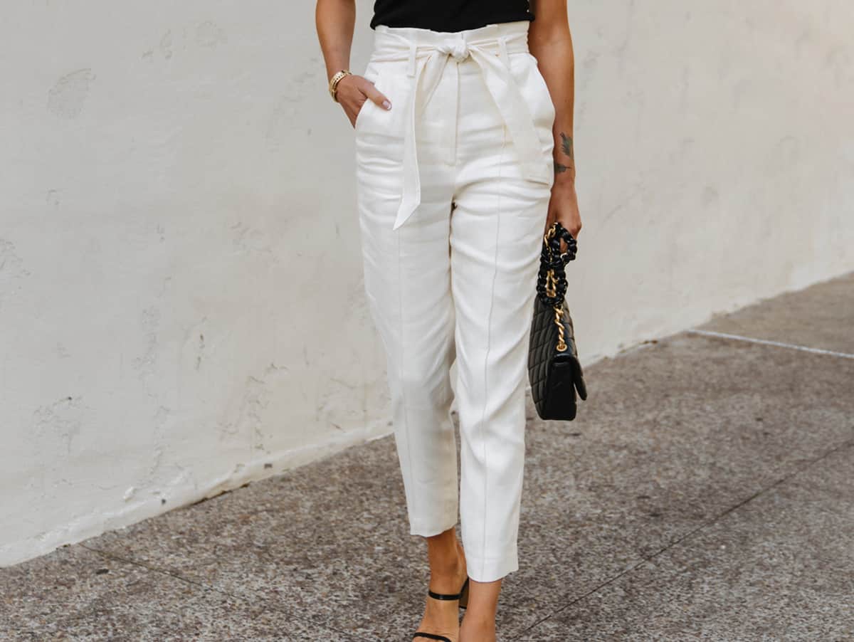 Fashion-Jackson-Wearing-Black-Tank-Top-White-Tie-Waist-Pants-Black-Sandals-black-top-white-pants-outfit-for-women-tie-waist-pants-outfit-street-style